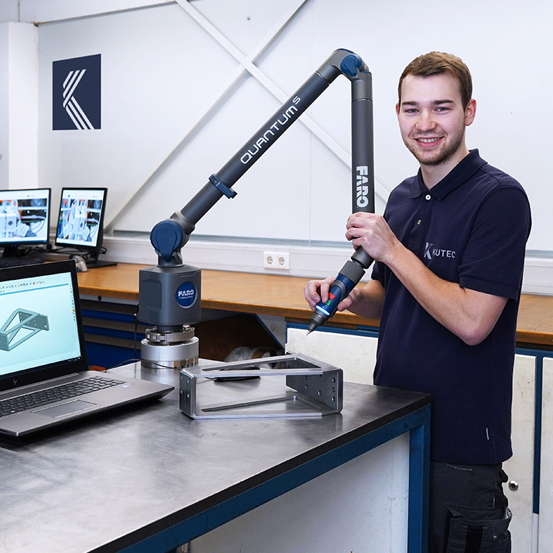 A KURRE employee checks a part from metal production for correct dimensions and quality